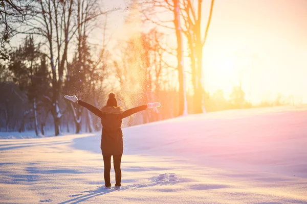 Vrouw gooien van sneeuw in de winter besneeuwde natuur — Stockfoto