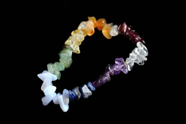 Colorful crystal chakras bracelet isolated on black — Stock Photo, Image