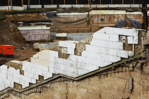 White tiled diagonal wall on messy construction site