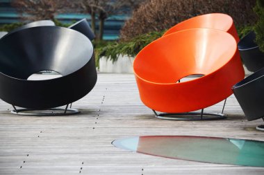 Dışarıda duran siyah ve turuncu modern sandalyeler.