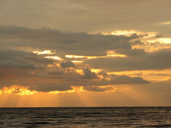 Sunset over the sea with beach chair — Stock Photo, Image