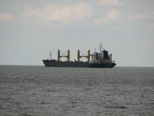 Ship far out to sea into haze transportation away from coast — Stock Photo, Image