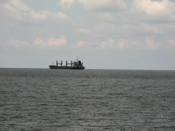 Ship far out to sea into haze transportation away from coast — Stock Photo, Image