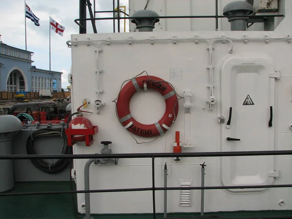 Ring life buoys on white boat.