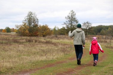 Bir alandaki kızıyla oynayan genç Baba