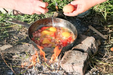 Çırpılmış yumurta tavası açık ateş üzerinde kömürler üzerinde kızarmış, bir açık ateşte pişirin