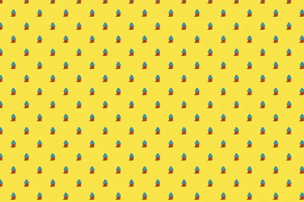 Trendy bright pattern made with toy house on a bright yellow background. Minimal concept