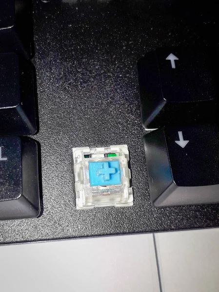 Mechanical keyboard with blue switch on the table.