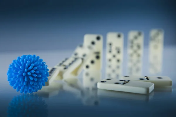 Concept of a domino effect caused by a virus