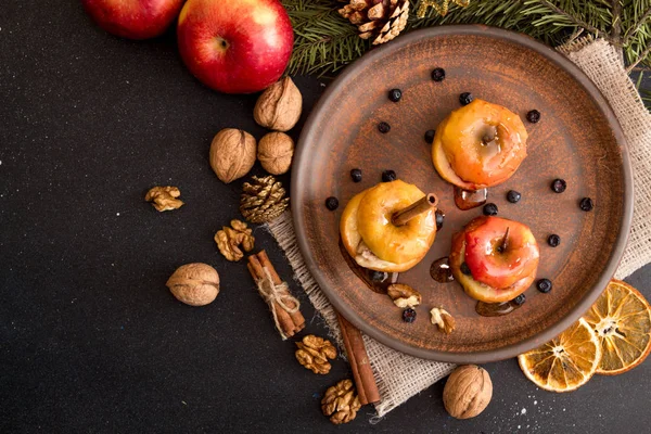 Baked apples on brown plate with holiday Christmas decoration — Stock Photo, Image