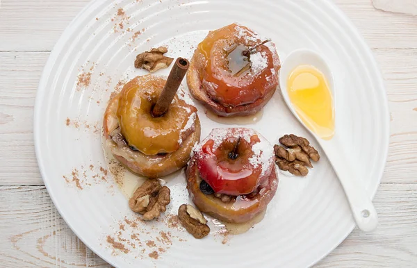 Bratäpfel gefüllt mit Walnüssen und Honig auf weißem Teller — Stockfoto