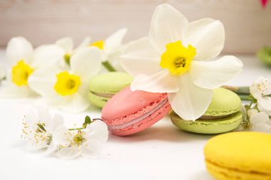 Macarons nergis ve kiraz blo beyaz arka planı üzerinde