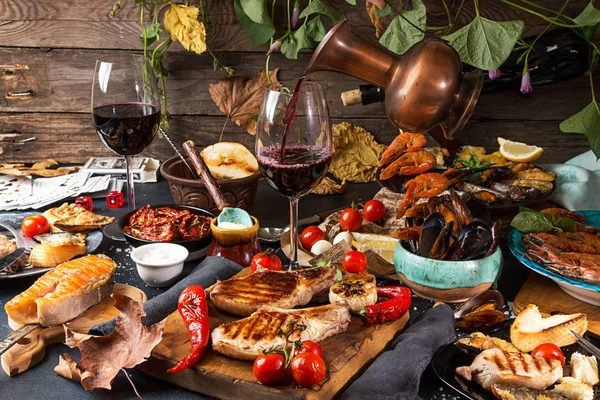 Overhead of dinner table. Assorted grilled barbecue meat and sea — Stock Photo, Image