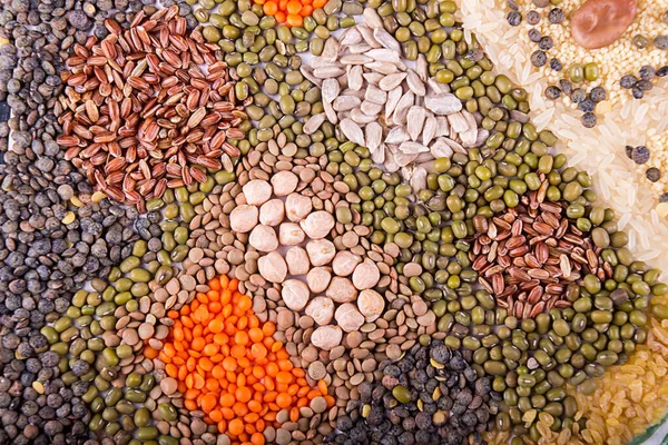 Food background. Stylized food map of various Legumes, sereals, beans, grain and seeds. Kind of lentils, bulgur, mash, chickpeas, sunflower seeds, couscous, rice.