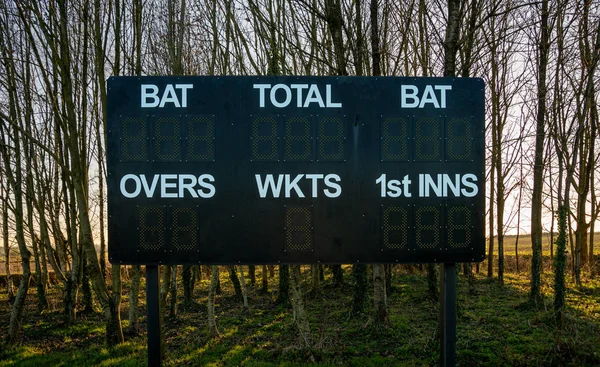 Cricket scoreboard at village country cricket club, England