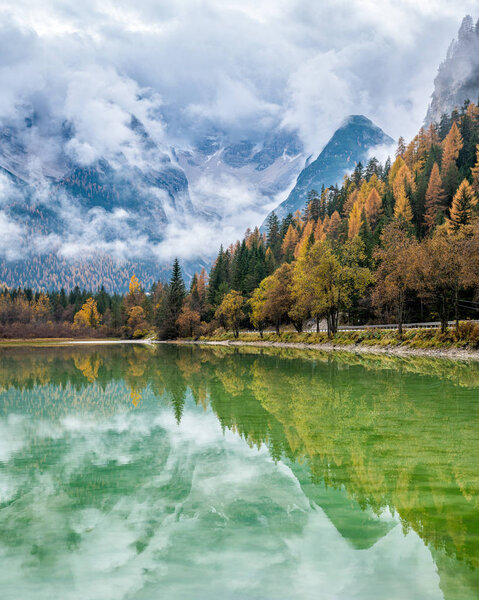 Foggy autumn day at Lake Landro, Province of Bolzano, Trentino Alto Adige, Italy.