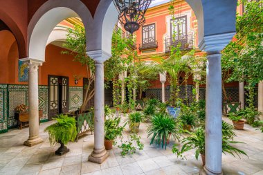 Colorful and elegant moorish cloister in Seville. Andalusia, Spain. June-02-2019 clipart
