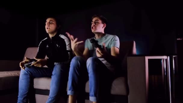 Having Fun Enjoy Victory Emotional Two Young Guys Sitting Couch — Stock Video