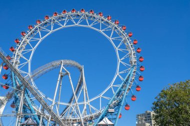 Ferris wheel and roller coaster at Tokyo Dome Japan clipart