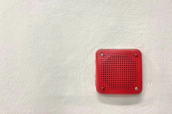 fire alarm mounted on cement wall for warning and security system and space for text