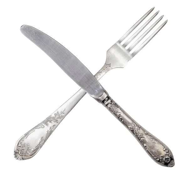 Messer und Gabel isoliert auf weiß gekreuzt — Stockfoto