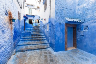 Chefchaouen, Fas, Afrika 'daki geleneksel ve tipik mimari detaylar ve mavi duvarlı ve çeşitli nesnelerle süslenmiş mavi Medine' nin güzel caddesi..