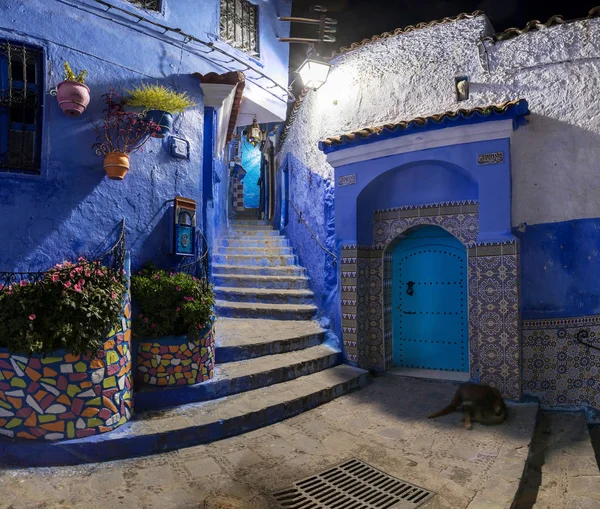 Traditional and typical moroccan architectural details in Chefchaouen, Morocco Africa Narrow and beautiful street of blue medina with blue walls and decorated with various objects.