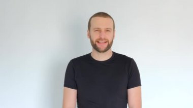 Sakallı yakışıklı genç adam kameraya küfür ediyor.