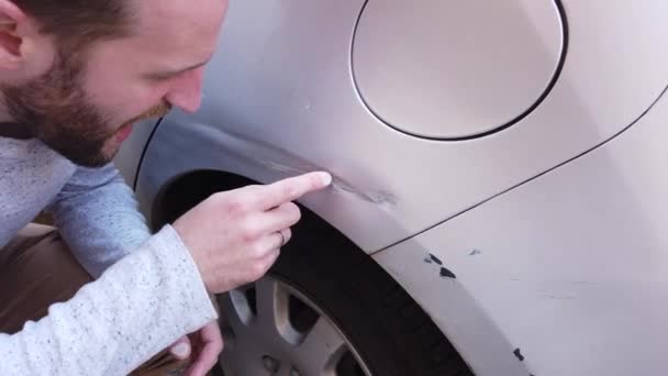 Handsome Young Man Inspects Large Scratch Rear Wing His Car — Stock Video