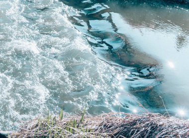 Fragment of a blue bubbling river, macro texture whimsical waves, glassy water splashes. clipart