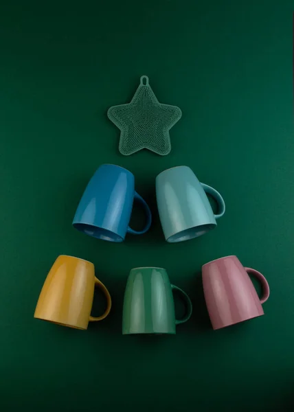 Alternative Christmas tree made of colorful cups on green background. Greeting card. Happy New Year and Merry christmas. — ストック写真