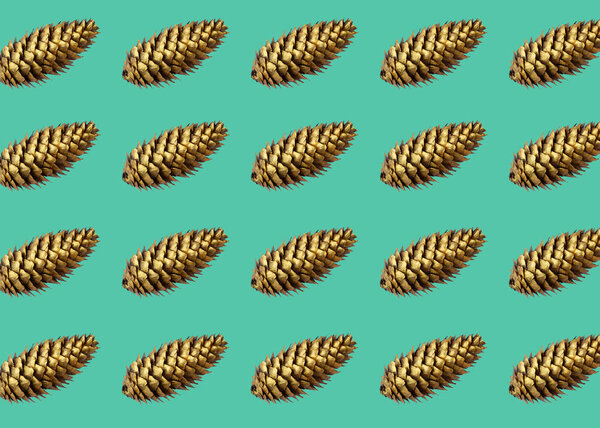 Pattern made from golden pine cone frame arrangement on green trendy color 2020 backdrop. christmas background wallpaper.