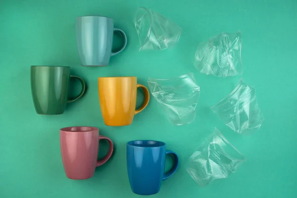 Ecology concept stop plastic pollution. Plastic waste. Pattern from ceramic mugs and plastic cups.