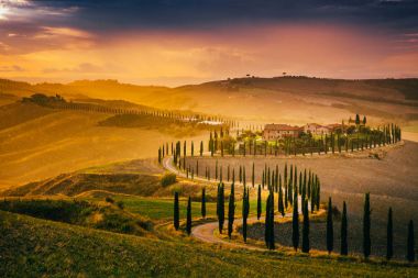 Tuscany, İtalya - 27 Eylül 2017: Güzel Toskana yağmur sonra gün batımında. Girit Senesi sonbaharda selvi ağaçları ile. İtalya, Europe.