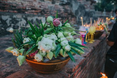 Lotus flowers, candles and incense sticks offered by Thai people at Asahna Bucha Day.