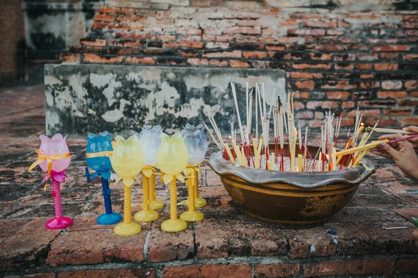 Candles and incense sticks offered by Thai people at Asahna Bucha Day.