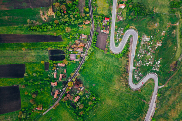 Curvy road from a drone view and agriculture fields