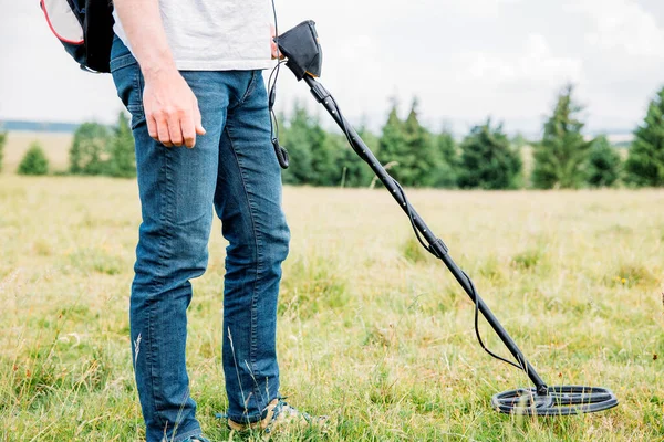 stock image Metal detector searching for treasure in the ground.