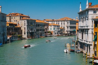 VENICE, ITALY -APRIL 8: Gondolas and tourists on April 8, 2019 in Venice, Italy. Venice has an average of 50,000 tourists a day.