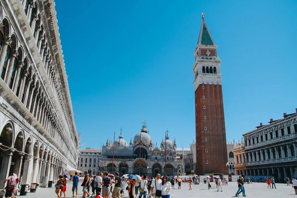 VENICE, ITALY -APRIL 8: Gondolas and tourists on April 8, 2019 in Venice, Italy. Venice has an average of 50,000 tourists a day.
