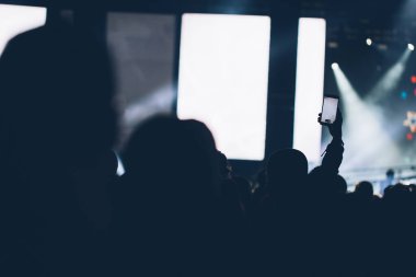 Sahne ışıkları ve bir müzik festivalinde elleri havada seyirci kalabalığı. Taraftarlar parti havasını seviyor.