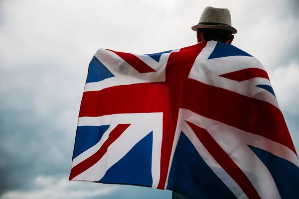 Man holding proudly the British flag. Patriot and supporter of Great Britain.