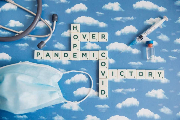 Flat lay of board game with letters about pandemic outbreak. Victory themed image when Covid-19 is over.