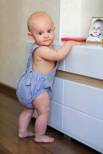 Cute Baby Learning Stand Holding Furniture — Stock Photo, Image