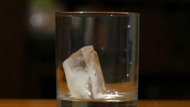 Servir le whisky avec de la glace dans un verre au ralenti 