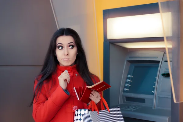 Funny Shopping Woman Holding a Penny in front of an ATM