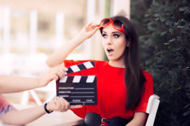 Surprised Actress with Oversized Sunglasses Shooting Movie Scene clipart
