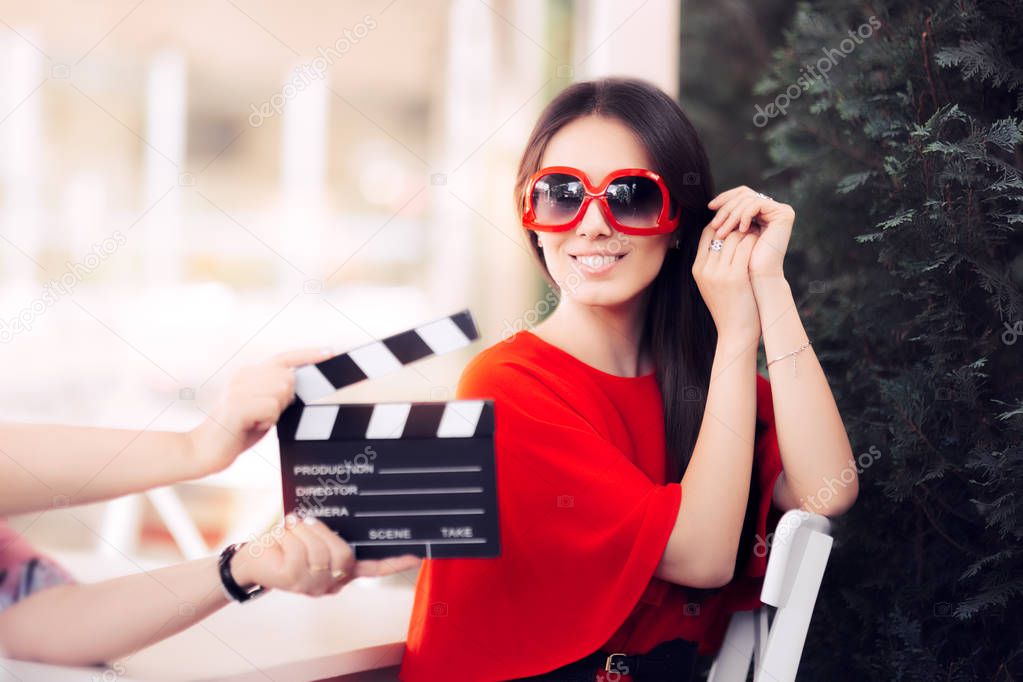 Happy Actress with Oversized Sunglasses Shooting Movie Scene