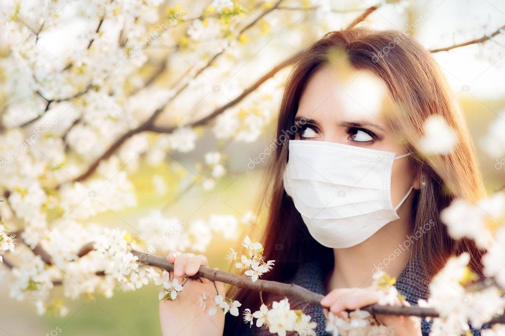 Woman with Respirator Mask Fighting Spring Allergies Outdoor