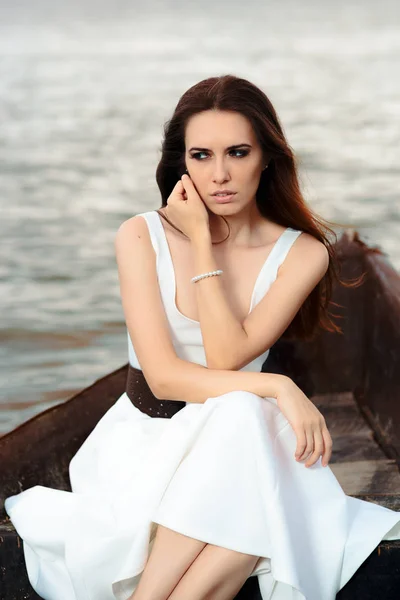 Sad Woman in White Dress Sitting in an Old Boat — Stock Photo, Image